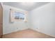 Compact bedroom features neutral walls and carpet, a bright window with curtains, and ample natural light at 9590 Lowell Blvd, Westminster, CO 80031