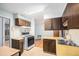A kitchen with white appliances and wood cabinets at 9590 Lowell Blvd, Westminster, CO 80031