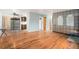A well lit living room with hardwood floors and views into the kitchen at 9590 Lowell Blvd, Westminster, CO 80031