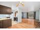 A well lit living room with hardwood floors and views into the kitchen at 9590 Lowell Blvd, Westminster, CO 80031