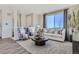 Cozy living room with comfortable seating, stylish decor, large windows, and plenty of natural light at 14107 Deertrack Ln, Parker, CO 80134