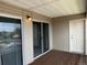 Balcony featuring wood plank flooring, white siding, and sliding glass door at 12304 W Cross Dr # 304, Littleton, CO 80127