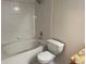 Bathroom featuring white tile tub, shower, and toilet, plus granite-topped vanity at 12304 W Cross Dr # 304, Littleton, CO 80127