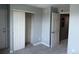 Bedroom with neutral carpet, sliding closet door, and white interior doors at 12304 W Cross Dr # 304, Littleton, CO 80127