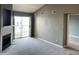 Carpeted living room featuring a sliding glass door to balcony and fireplace at 12304 W Cross Dr # 304, Littleton, CO 80127