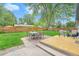 A backyard with a well-maintained lawn, a patio seating area, and mature trees offering an outdoor living at 6147 Jellison Way, Arvada, CO 80004