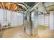 Unfinished basement showing the HVAC, water heater, and storage shelving at 6147 Jellison Way, Arvada, CO 80004