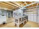 The unfinished basement features utility space, workbench, laundry area and storage offering practical potential at 6147 Jellison Way, Arvada, CO 80004