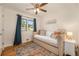 Cozy bedroom with wood floors, a ceiling fan, and a window providing ample natural light at 6147 Jellison Way, Arvada, CO 80004