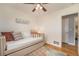 Comfortable bedroom with hardwood floors and a door leading to an ensuite bathroom at 6147 Jellison Way, Arvada, CO 80004