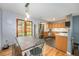 Bright kitchen features wood cabinets, stainless steel appliances, and an adjacent dining area at 6147 Jellison Way, Arvada, CO 80004