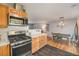 Modern kitchen features stainless steel appliances, updated countertops, and a cozy adjacent dining area at 6147 Jellison Way, Arvada, CO 80004