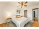 Bright main bedroom featuring a ceiling fan, closet, and warm hardwood floors at 6147 Jellison Way, Arvada, CO 80004