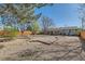 Wide backyard with landscaping with an outdoor patio and wooden fence at 125 S Fulton Ave, Fort Lupton, CO 80621