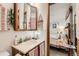 Bathroom with vanity sink, mirror, and adjacent view of the bedroom through an open door at 125 S Fulton Ave, Fort Lupton, CO 80621