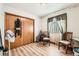 Bedroom with hardwood floors, a window with curtains, and a double-door closet for storage at 125 S Fulton Ave, Fort Lupton, CO 80621
