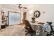 Open dining area with a ceiling fan, French doors, neutral carpet, and lots of natural light at 125 S Fulton Ave, Fort Lupton, CO 80621