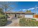 Charming brick home featuring a well-maintained yard with mature landscaping and a two-car garage at 125 S Fulton Ave, Fort Lupton, CO 80621