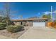A well maintained single-story brick home with a two-car garage, a long driveway, and minimal landscaping at 125 S Fulton Ave, Fort Lupton, CO 80621