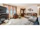 Inviting living room featuring a fireplace, neutral carpet, comfortable seating, and stylish decor at 125 S Fulton Ave, Fort Lupton, CO 80621