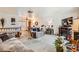 Spacious living room featuring a fireplace, neutral carpet, open layout, and abundant natural light at 125 S Fulton Ave, Fort Lupton, CO 80621