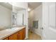 Powder room featuring wooden vanity, sink, large mirror and tile floors at 6112 S Joplin Way, Centennial, CO 80016