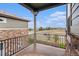 Balcony view with wood floors and black metal railing overlooking trees and neighborhood street at 24943 E Phillips Pl, Aurora, CO 80016