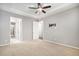 Bright, carpeted bedroom with ceiling fan and white doors to adjoining rooms at 24943 E Phillips Pl, Aurora, CO 80016