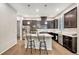 Contemporary kitchen featuring stainless steel appliances, a central island, and dark wood cabinetry at 24943 E Phillips Pl, Aurora, CO 80016