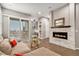 Stylish living room showcases a modern fireplace, comfortable seating, and a sliding door to a balcony at 24943 E Phillips Pl, Aurora, CO 80016