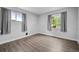 Well-lit bedroom featuring hardwood floors, natural lighting, and neutral wall color at 1865 S Knox Ct, Denver, CO 80219