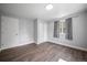 Bright bedroom featuring wood floors, grey walls, natural light, and closet at 1865 S Knox Ct, Denver, CO 80219