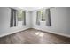 Bedroom featuring hardwood floors, large windows, and neutral wall color to compliment any decor style at 1865 S Knox Ct, Denver, CO 80219