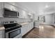 Bright kitchen featuring new appliances, granite countertops and seamless transition to the living area at 1865 S Knox Ct, Denver, CO 80219