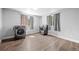 Spacious laundry room with wood floors, natural light, and modern appliances at 1865 S Knox Ct, Denver, CO 80219