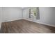 Bright living room featuring hardwood floors, neutral walls, and a door that is painted white with glass window panes at 1865 S Knox Ct, Denver, CO 80219