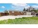 Lush backyard with brick house, basketball net, shed, and greenery offers privacy and space for outdoor activities at 11261 Clarkson St, Northglenn, CO 80233