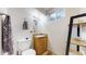 Compact bathroom features a toilet, vanity, and mirror, maximizing space in a functional design at 11261 Clarkson St, Northglenn, CO 80233