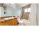 Bright bathroom features a shower, toilet, vanity and a window for natural light at 11261 Clarkson St, Northglenn, CO 80233