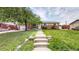 Wide angle view showing home exterior with brick facade and well-maintained lawn at 11261 Clarkson St, Northglenn, CO 80233