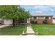 Charming single-story home featuring a brick facade, covered porch, and well-maintained lawn at 11261 Clarkson St, Northglenn, CO 80233