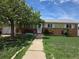 Charming single-story home with a brick facade, well-maintained lawn, and sidewalk leading to the front door at 11261 Clarkson St, Northglenn, CO 80233