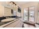 Bathroom with blue tile counter and a window overlooking an outdoor deck at 2684 S Adams St, Denver, CO 80210