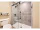 Modern bathroom with a glass-enclosed shower featuring gray tiles and black hardware at 2684 S Adams St, Denver, CO 80210
