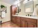 Bathroom featuring a double vanity with wood cabinets, white countertops, and tile flooring at 2684 S Adams St, Denver, CO 80210