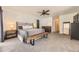 Spacious bedroom featuring neutral carpet, ceiling fan, and wooden bench at the foot of the bed at 2684 S Adams St, Denver, CO 80210