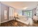 Cozy bedroom featuring hardwood floors, neutral walls, and a light fixture at 2684 S Adams St, Denver, CO 80210