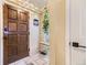 Welcoming entryway with a solid wood door, tiled floor, and a convenient shoe rack with coat hooks at 2684 S Adams St, Denver, CO 80210