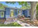 Close-up of the blue home's entrance, featuring a stylish front door and charming outdoor seating area at 2684 S Adams St, Denver, CO 80210
