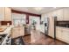 Well-lit kitchen featuring modern appliances, white cabinetry, and seamless integration into adjacent living spaces at 2684 S Adams St, Denver, CO 80210